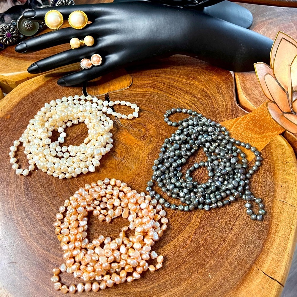 3 strands of baroque, freshwater pearls with three pairs of matching earrings.